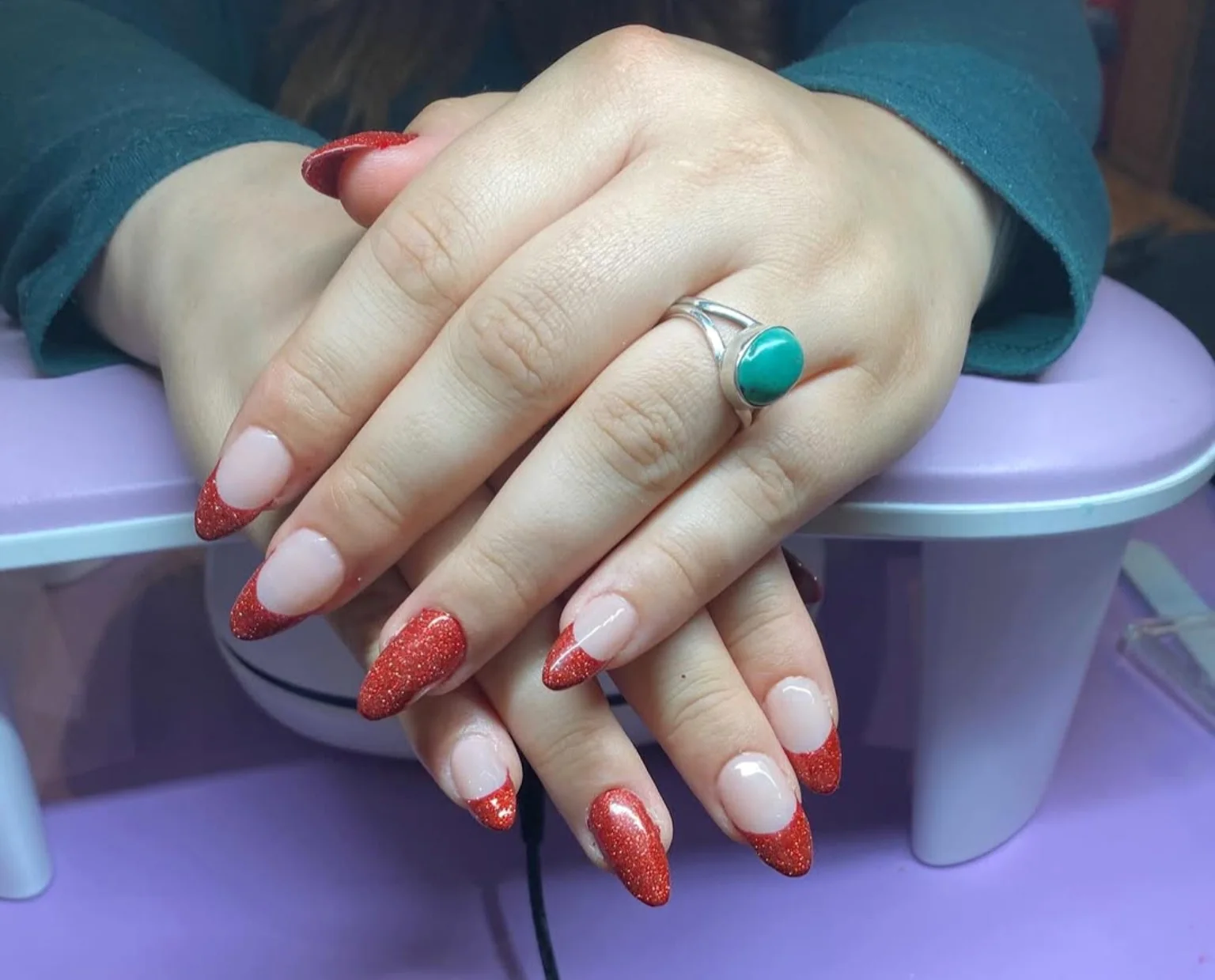 Almond nails with sparkling red French tips