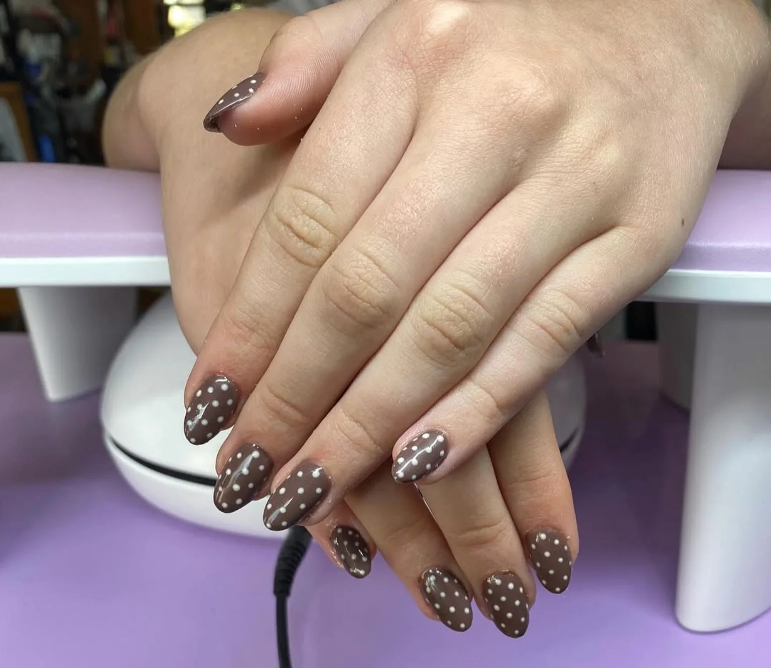 Brown almond nails with white dotted nail art