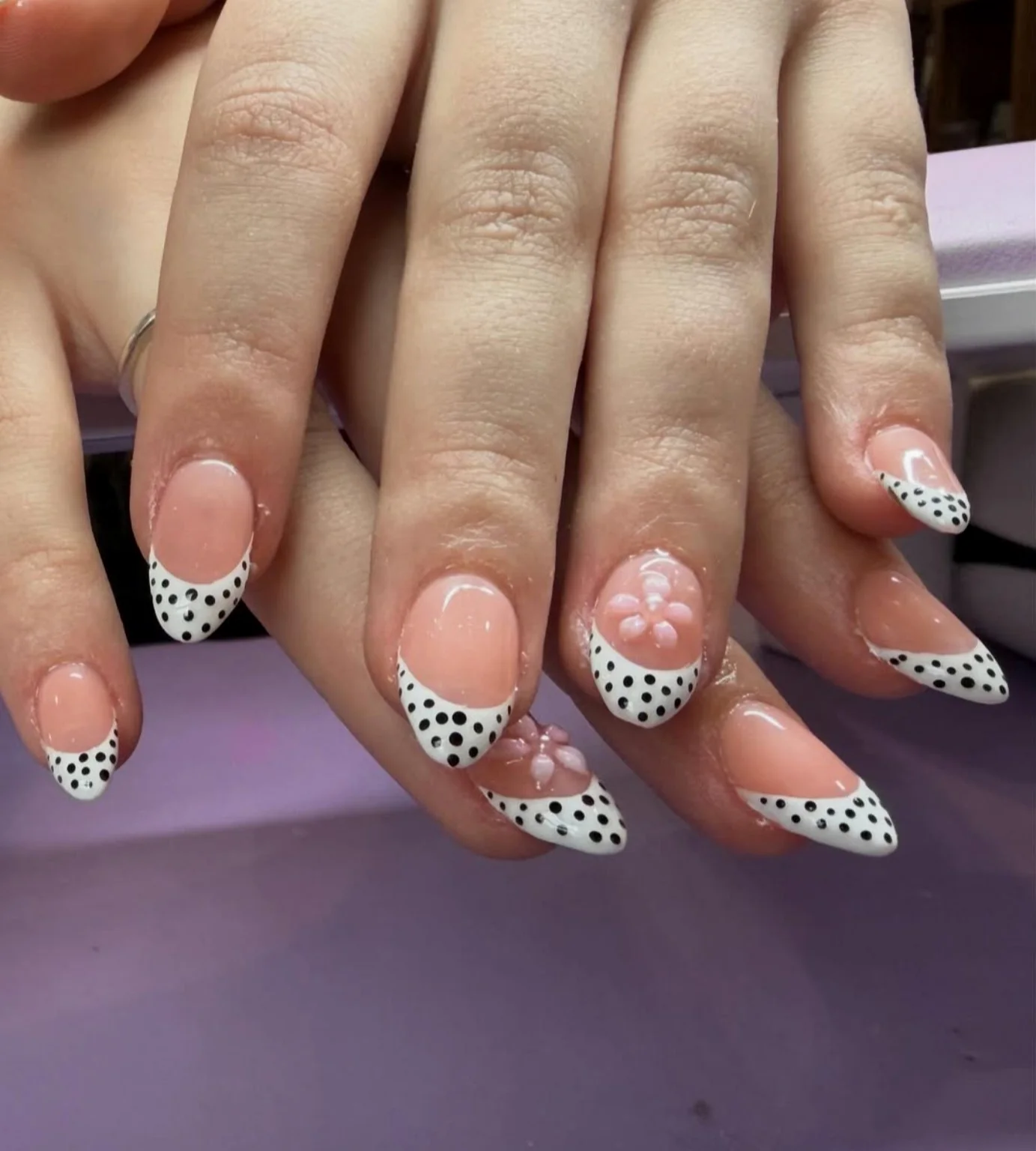 White French tips with black polka dots and raised pink flowers